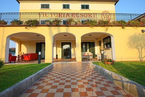 a house with a patio and a brick walkway at Victoria Resort in Ascea