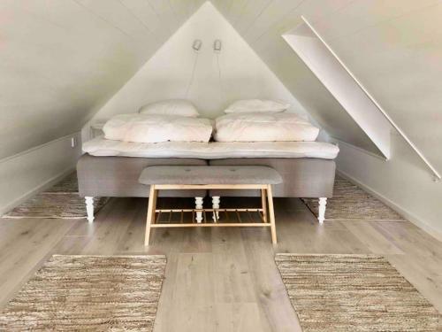 a bedroom with a bed in the attic at Nybyggt boende nära hav och natur. in Störlinge