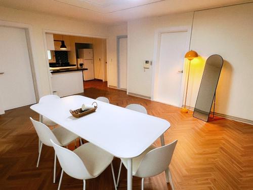 a white table and chairs in a room at Jnineguesthouse in Seoul