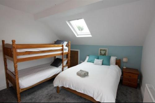 a bedroom with two bunk beds and a window at Seaglass Cottage - Redcar in Redcar
