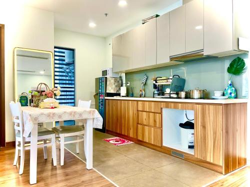 a kitchen with a table with chairs and a counter at Ecogreen HCM - DPL Homestay SG in Ho Chi Minh City