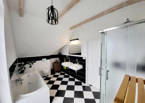 a bathroom with a black and white checkered floor at ACH TO TU KARPACZ in Karpacz