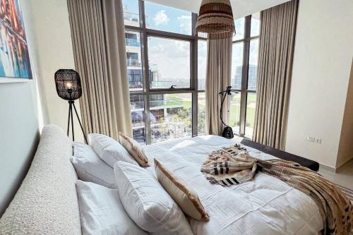 a large bed in a room with a large window at Spacious Lux Golf View Apartment in Dubai Marina