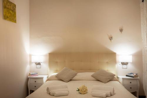 a bedroom with a large bed with two night stands at Il Torrione in Castiglione del Lago