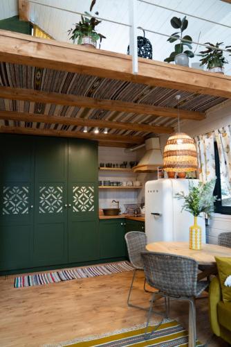 a kitchen with green cabinets and a table with chairs at Chili Shale in Yablunytsya