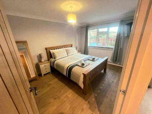 a bedroom with a bed and a window at Comfortable Norfolk Bungalow in Dersingham
