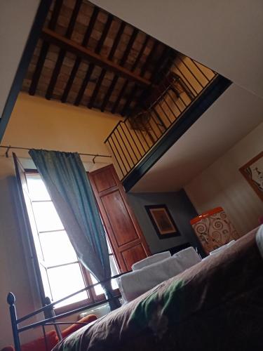 a bedroom with a bed and a window at Dimora del Conte in Pisa