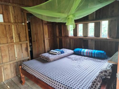 a bedroom with two beds in a wooden cabin at Friend of Nature Bungalow in Koh Rong Island