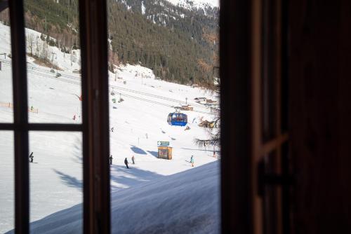 a view of a ski slope from a window at Chalet Marmotta CULM - Luxus Chalet Ski-In Ski-Out in Sankt Anton am Arlberg