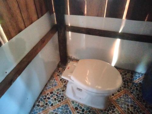 a bathroom with a white toilet in a room at Friend of Nature Bungalow in Koh Rong Island