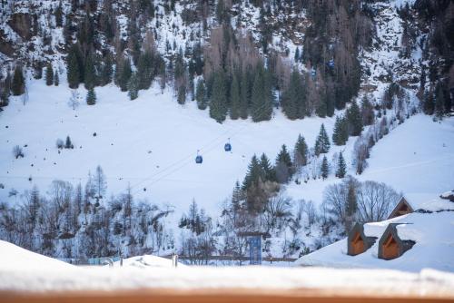 a snow covered mountain with a ski lift at Chalet Marmotta CULM - Luxus Chalet Ski-In Ski-Out in Sankt Anton am Arlberg