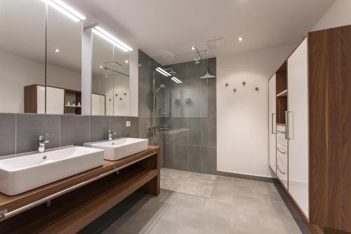 a bathroom with two sinks and a shower at Appartement Traumblick by Schladming Appartements in Schladming