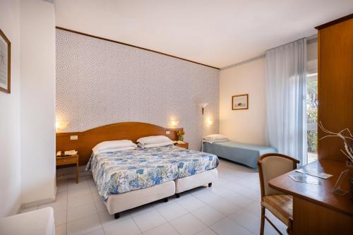 a hotel room with a bed and a desk at Villa Dei Principi Hotel in Terracina