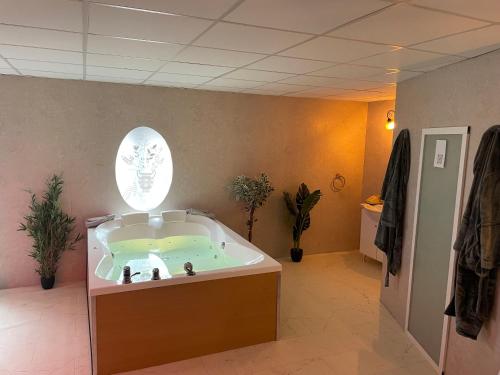 a jacuzzi tub in the middle of a room at Cinema Paradiso - Appartement de charme avec Sauna, Hammam, spa in Issoudun