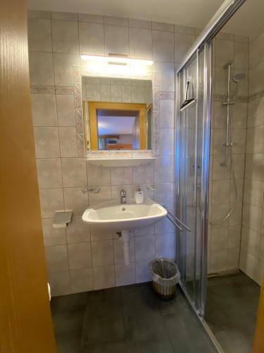 a bathroom with a sink and a shower at Bella Mira in Samnaun - Laret