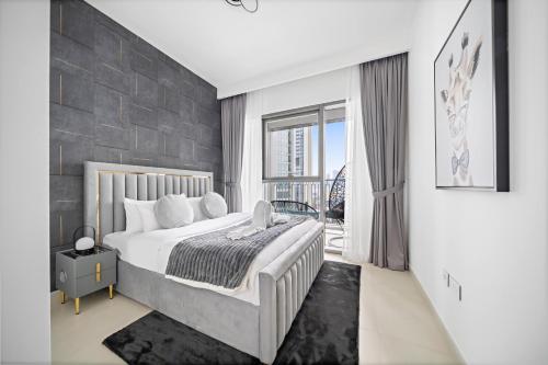 a bedroom with a king sized bed with a stone wall at Amazing Burj Khalifa Views with Direct Dubai Mall Access, 2BR Apartment in Downtown Dubai in Dubai