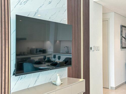 a large flat screen tv hanging on a wall at Amazing Burj Khalifa Views with Direct Dubai Mall Access, 2BR Apartment in Downtown Dubai in Dubai