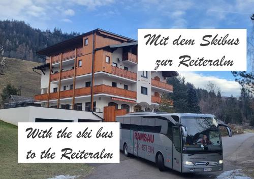 a bus is parked in front of a building at Unser Hoamat Appartement in Schladming