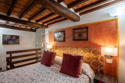 a bedroom with a large bed in a room at Il Torrione in Castiglione del Lago