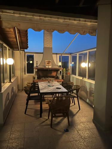 a patio with a table and chairs on a balcony at Marvic House in Exaplátanos