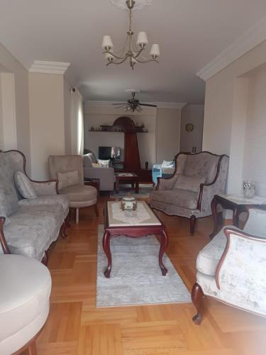 a living room with couches and a coffee table at Luxury apartment in laurent in Alexandria