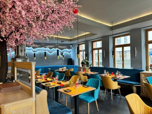 um restaurante com mesas e cadeiras e flores cor-de-rosa em Zur Krone Leimen em Leimen