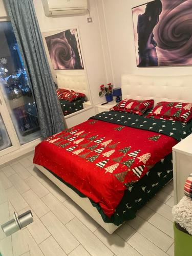 a bedroom with a bed with a red comforter at Blue light ultracentral in Craiova