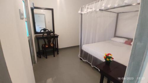 a bedroom with a bunk bed and a mirror at Green House, Upstairs Apartment in Madihe East