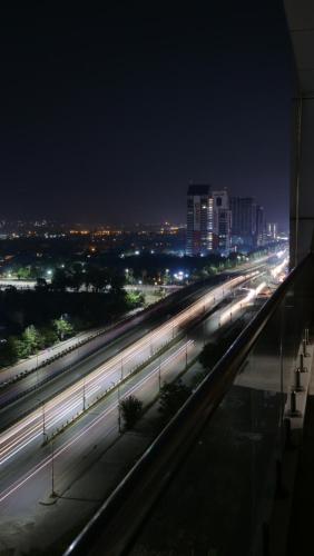 a city at night with lights on a highway at Cherry On Top-Luxe Living in Islamabad's Skyline Elysium in Islamabad