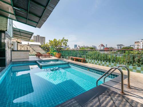 a swimming pool on top of a building at Royal Ivory Sukhumvit Nana in Bangkok