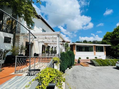 a white house with a porch and a patio at Conti B&B Suite Ponte Amato in Gallicano nel Lazio