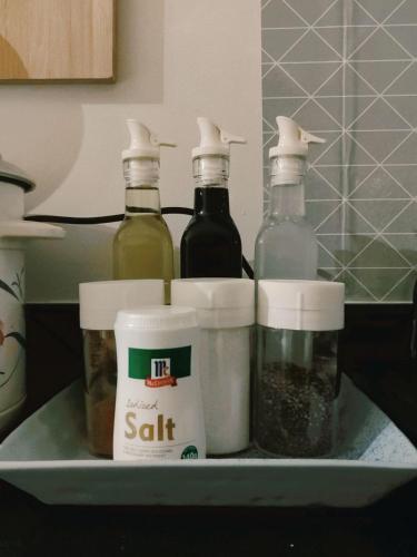 a shelf with four bottles of oil and spices at SMDC Grass Residences in Manila