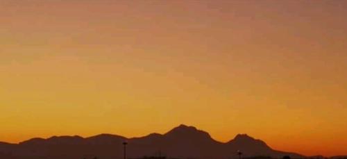 an orange sunset with mountains in the background at villa Angelina house in Ripa Teatina