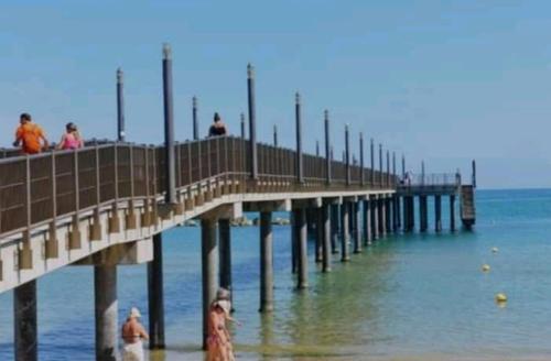 people walking on the pier at the beach at villa Angelina house in Ripa Teatina