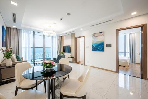 a living room with a table and chairs at Landmark 81 And Vinhomes PANORAMA - ANGIA Hospitality in Ho Chi Minh City