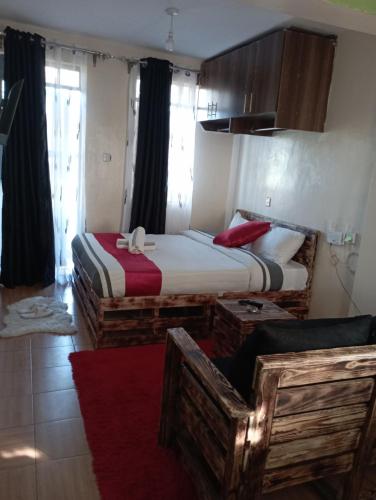 two twin beds in a room with a red rug at Cozy furnished studio in Nairobi