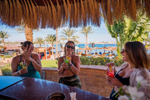a group of women sitting at a table with drinks at Marina Sharm Hotel in Sharm El Sheikh