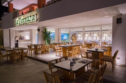 a dining room with tables and chairs and a restaurant at Marina Sharm Hotel in Sharm El Sheikh