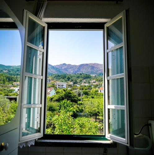 an open window with a view of a city at Casa Vista da Serra - Covilhã in Covilhã