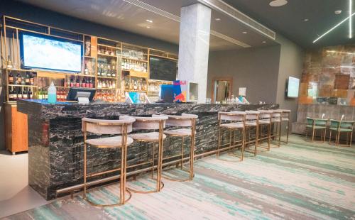 a bar in a restaurant with stools at a counter at Marina Sharm Hotel in Sharm El Sheikh