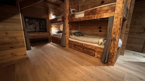 a bedroom with two bunk beds in a log cabin at Chillouthouse Idre in Idre