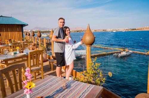 a man and a woman standing on a dock at Marina Sharm Hotel in Sharm El Sheikh