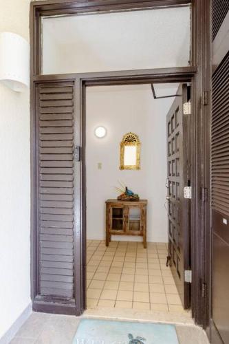 an open door to a hallway with a table at Carey Beach Villa in Humacao