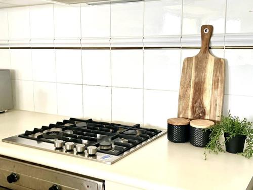 a stove top oven sitting on a counter in a kitchen at A Cozy 2B2B Apt Next To Carlton Garden W/ Parking in Melbourne