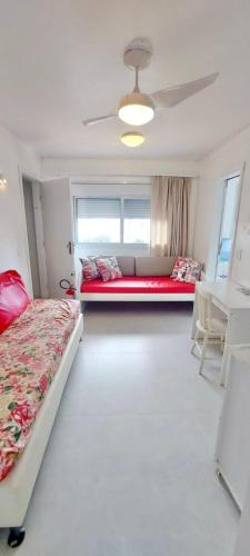 a bedroom with two beds and a couch in it at Próximo shopping Beira Mar in Florianópolis