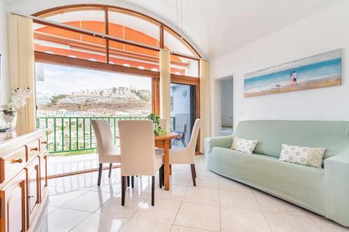 a living room with a table and a couch at 1005 Ocean view house La cascada in Puerto Rico de Gran Canaria