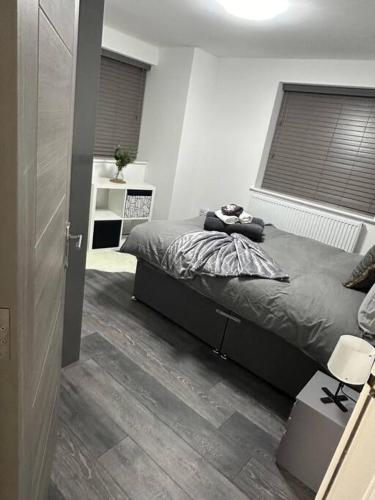 a bedroom with a bed and a window with blinds at 2Bed flat In Leicester ! in Leicester