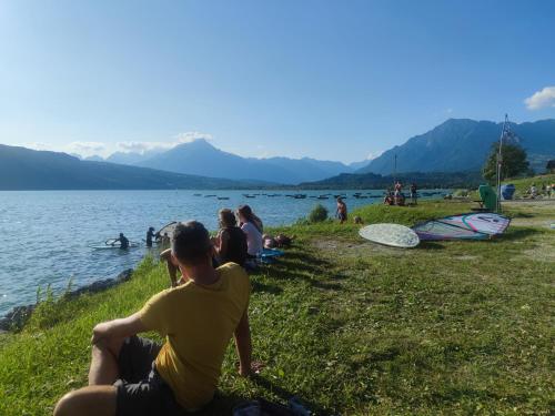 a group of people sitting on the grass by a lake at BBConegliano Borlini in Conegliano