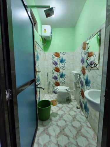 a bathroom with a toilet and a sink at Bamni Tourist Lodge in Bāghmundi