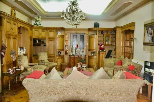 a living room with a couch and a chandelier at Luxury Vacation Villa in Cairo